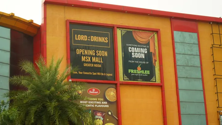 Lord of the Drinks 'opening soon' hoarding on the facade at MSX Mall, Greater Noida