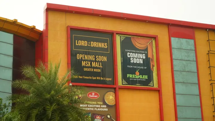 Lord of the Drinks 'opening soon' hoarding on the facade at MSX Mall, Greater Noida