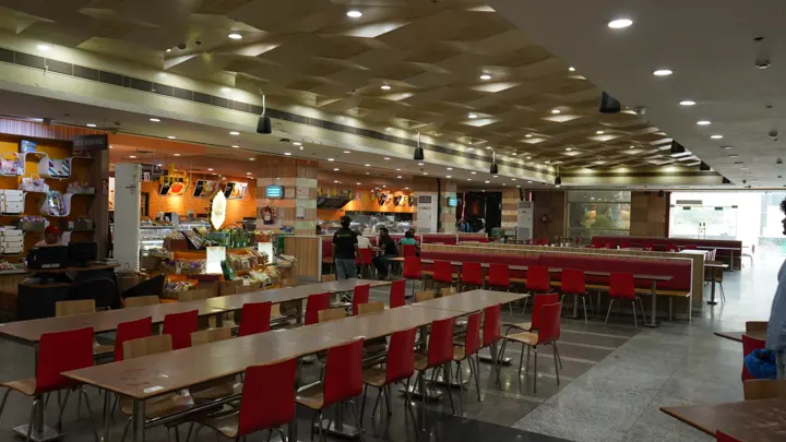 Food court seating with long communal tables at MSX Mall, Greater Noida